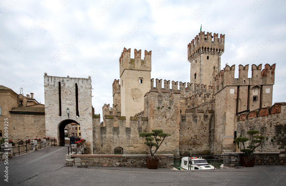 Castle in Sirmione. View to the medieval Rocca Scaligera castle (13th century) in Sirmione town on Garda lake near Verona, Italy. Access point to the historical center of Sirmione.