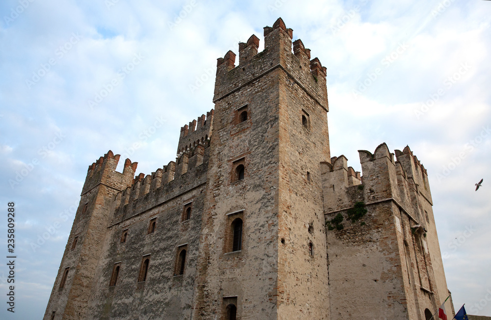 Castle in Sirmione. View to the medieval Rocca Scaligera castle in Sirmione town on Garda lake, Italy. Scaliger Castle (13th century) in Sirmione on Garda lake near Verona, Italy