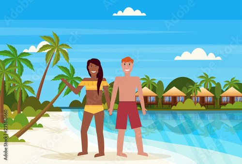 mix race couple on tropical island with villa bungalow hotel on beach seaside green palms landscape summer vacation concept flat horizontal