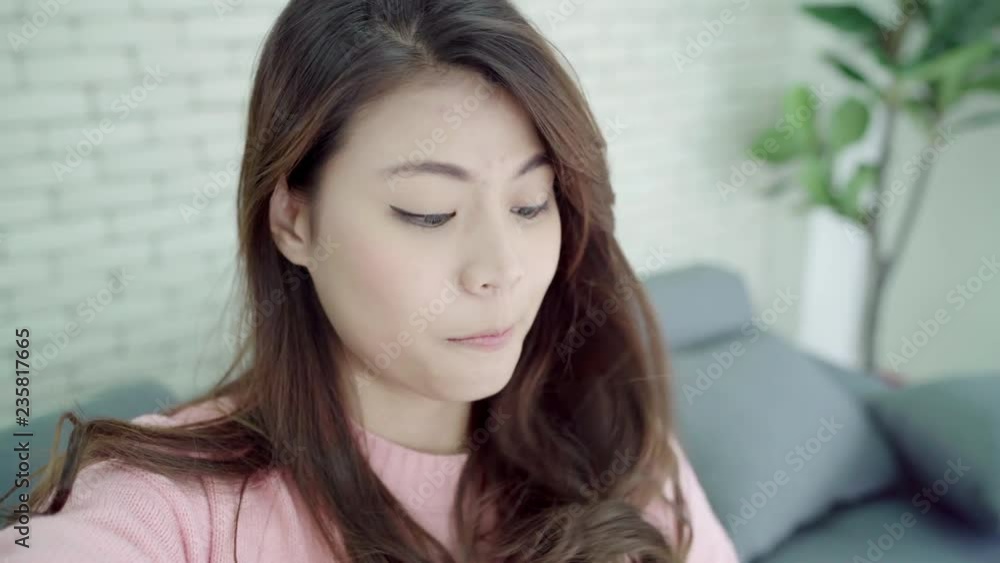 Asian blogger woman using smartphone recording vlog video in living room at home,female enjoy funny moment while lying on the sofa when relax at home. Lifestyle blogger making video at home. Asian blogger woman using smartphone recording vlog video in living room at home,female enjoy funny moment while lying on the sofa when relax at home. Lifestyle blogger making video at home.