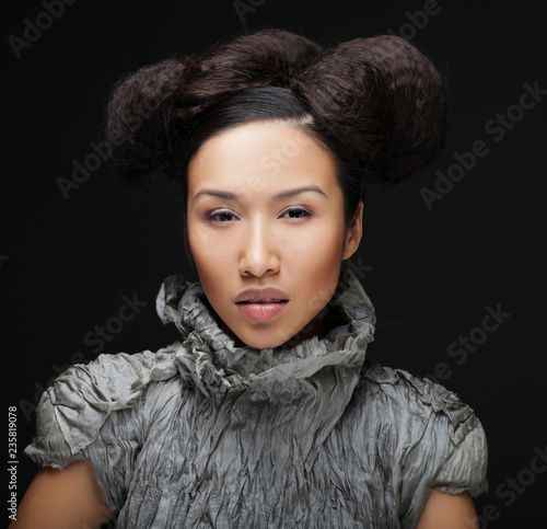 Beauty and fashion concept: young Asian fashion model in grey dress