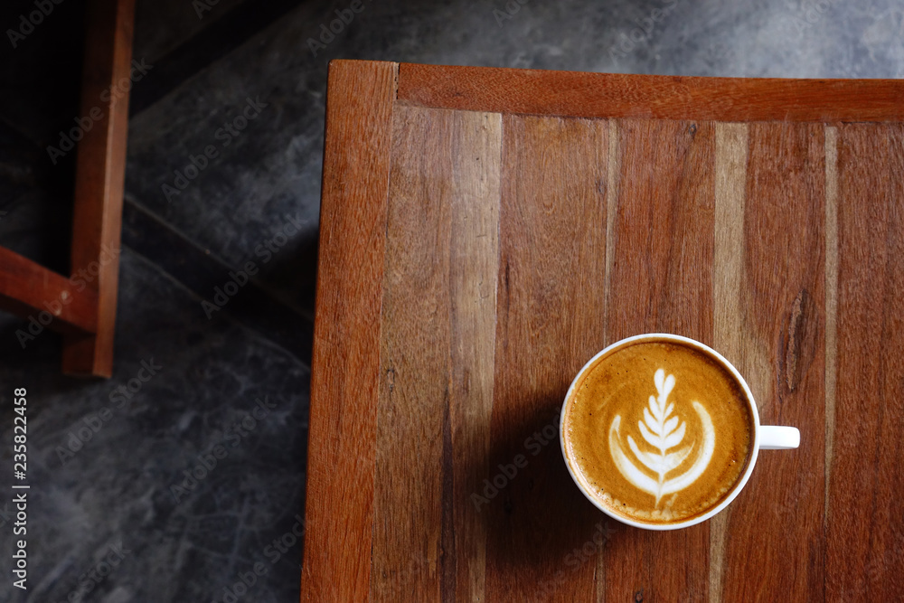 a cup of latte art coffee on wooden background a cup of latte art coffee on wooden background