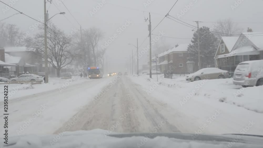 TORONTO, CANADA on Dec 16th: Driving on O'Connor Blvd on December 16th, 2016 in Toronto, Canada. A sudden snowstorm hit Toronto in the afternoon bringing approx 12 cms of snow. TORONTO, CANADA on Dec 16th: Driving on O'Connor Blvd on December 16th, 2016 in Toronto, Canada. A sudden snowstorm hit Toronto in the afternoon bringing approx 12 cms of snow.