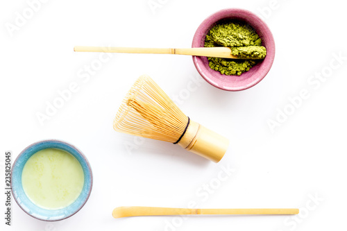 Brew matcha green tea. Matcha powder, ready matcha tea, whisk on white background top view copy space