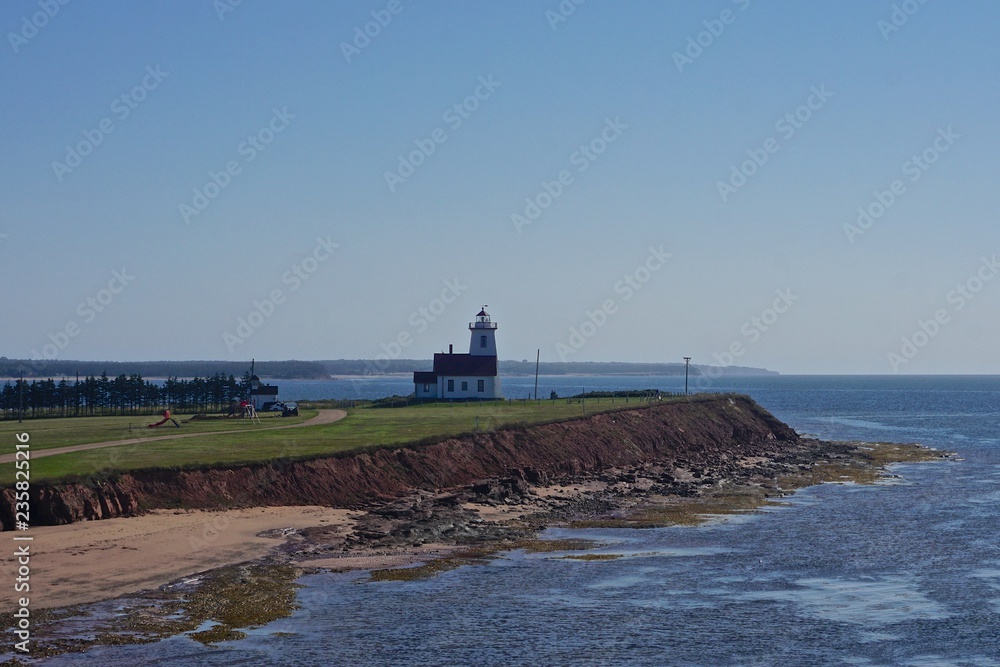 The Wood Islands Lighthouse (1876) on the southeast shore of Prince Edward Island, Canada, viewed from the ferry to Pictou, Nova Scotia.