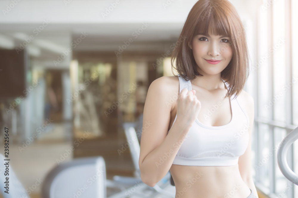 healthy strong fitness woman working out in gym. portrait of fitness woman in gym posing for strong body, gym workout, fitness people, healthy lifestyle concept. asian adult fitness woman model healthy strong fitness woman working out in gym. portrait of fitness woman in gym posing for strong body, gym workout, fitness people, healthy lifestyle concept. asian adult fitness woman model