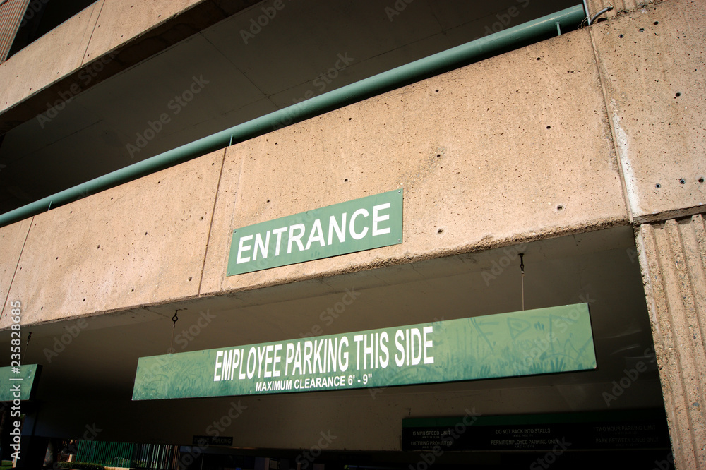 aged entrance sign on parking structure aged entrance sign on parking structure