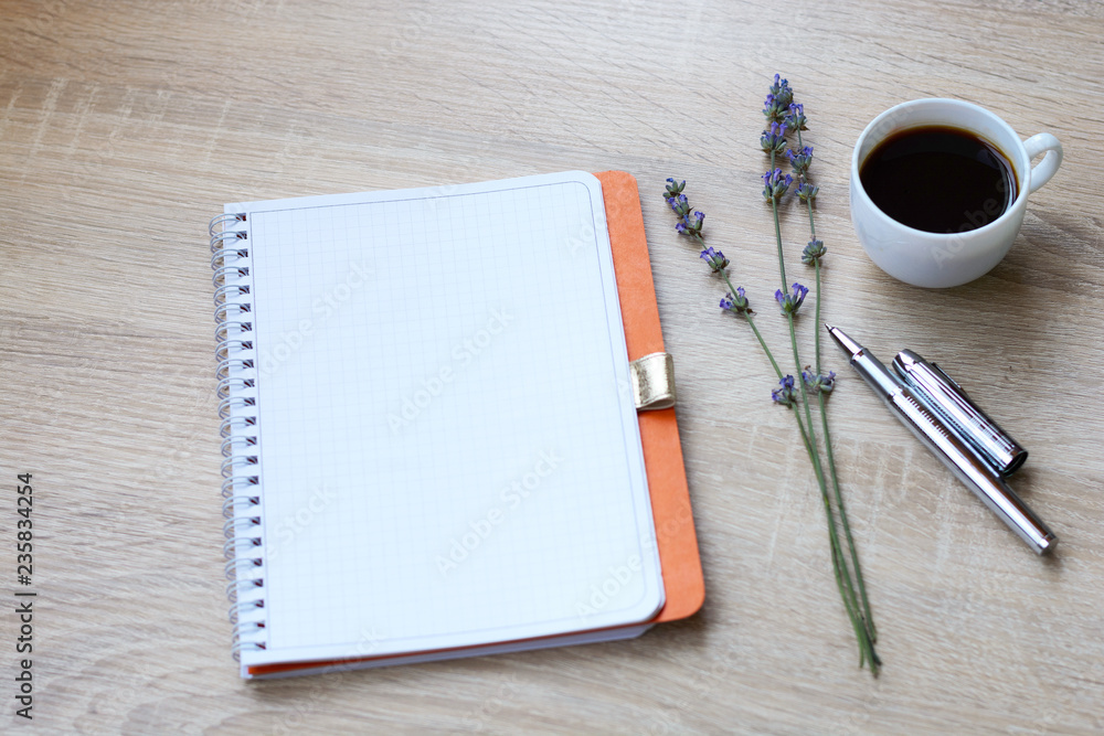 Notepad, pen, flowers (lavender) on a wooden desk. Writer; Notepad, pen, flowers (lavender) on a wooden desk. Writer;