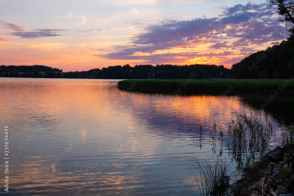 Sunset landcape of Wulpinskie Lake at the Masuria Lakeland region in Poland in summer season