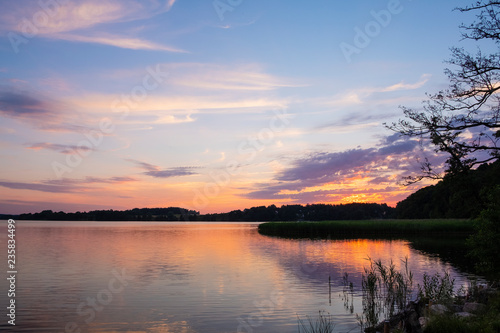 Sunset landcape of Wulpinskie Lake at the Masuria Lakeland region in Poland in summer season
