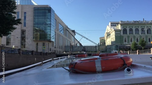 The ship goes on the Neva River. On the horizon you can see the Mariinsky Theater. photo