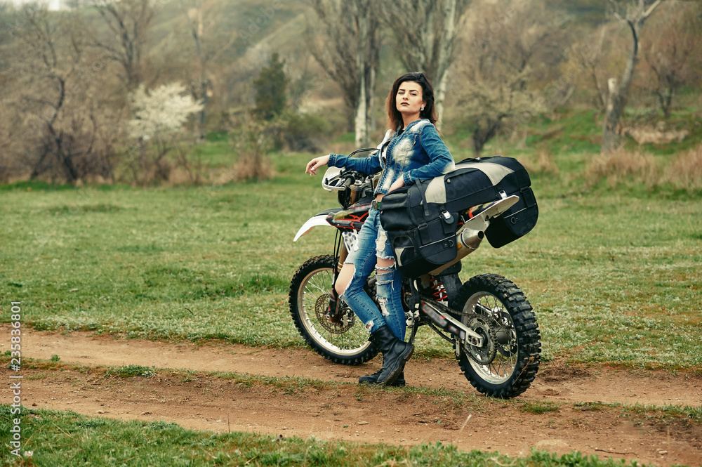 A young girl mototourist in nature . Motorcycle travel concept A young girl mototourist in nature . Motorcycle travel concept