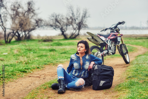 A young girl mototourist in nature . Motorcycle travel concept