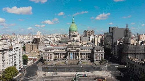 Aerial drone view of Buenos Aires national congress parliament building with dome roof, roman horse carriage statute and argentine flag