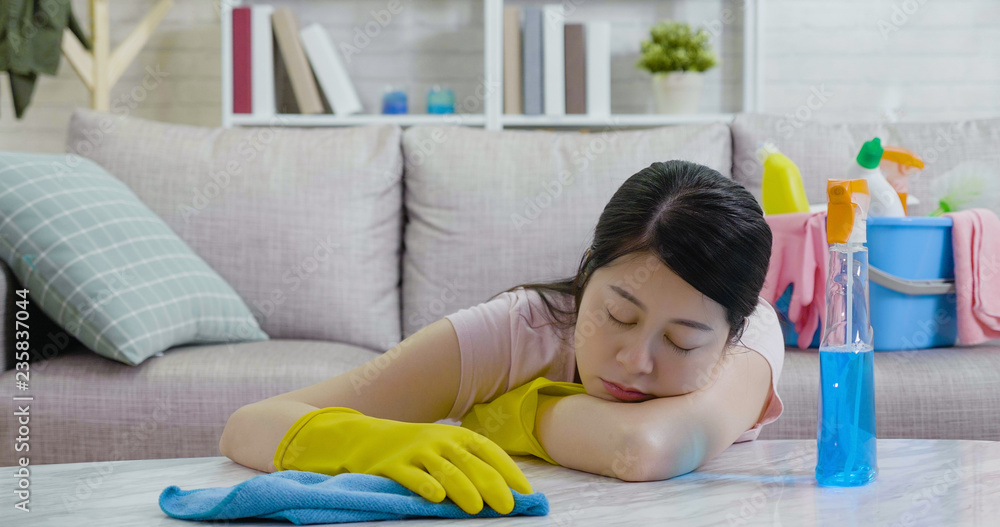 woman sleeping while doing housework woman sleeping while doing housework