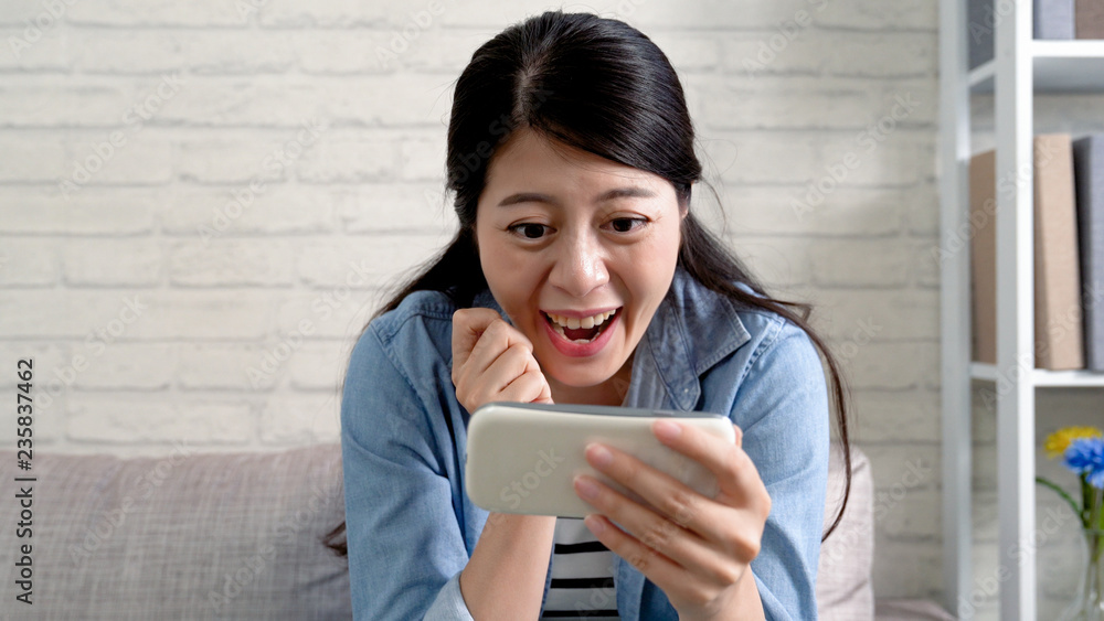 Happy casual housewife using a mobile phone Happy casual housewife using a mobile phone