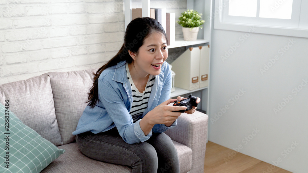 asian female playing video games on console asian female playing video games on console