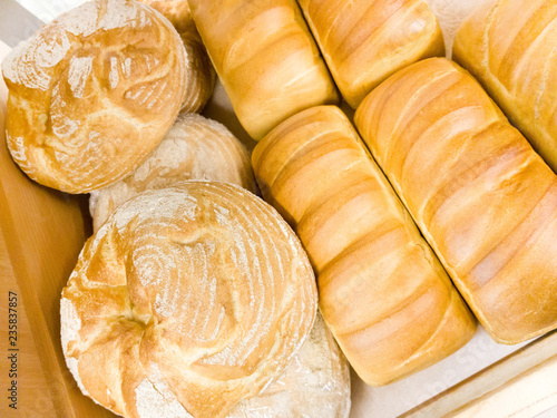 Fresh crisp ordinary and round bread on the shelf in the store.