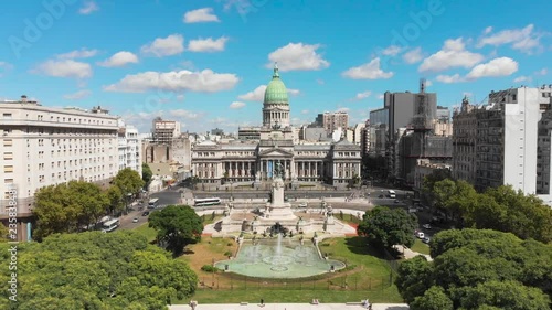 Aerial drone view of Buenos Aires national congress parliament building with dome roof, fountain plaza park and statute