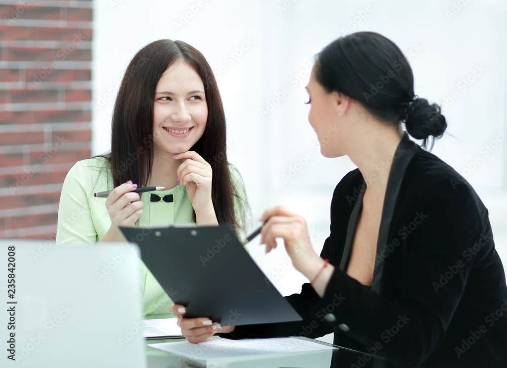 close up. two business women discussing documents close up. two business women discussing documents