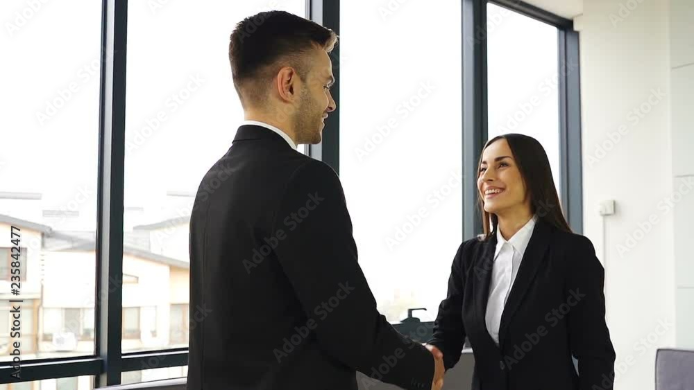 Pretty smiling businesswoman, shake hands with man partner when meeting. Slow motion, slider shot Pretty smiling businesswoman, shake hands with man partner when meeting. Slow motion, slider shot
