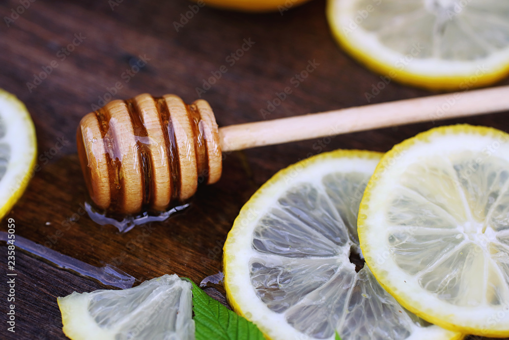 On a wooden texture background a lemon and honey On a wooden texture background a lemon and honey