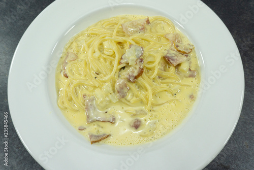 Spaghetti Carbonara in a dish white floor table,Top view,Copy space..