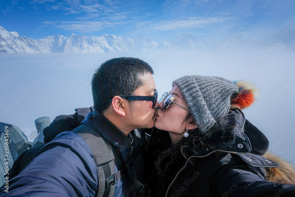 Young sweet couple taking selfie kiss at Schilthorn with the stunning view  of Swiss Skyline in Switzerland – Stock-Foto | Adobe Stock