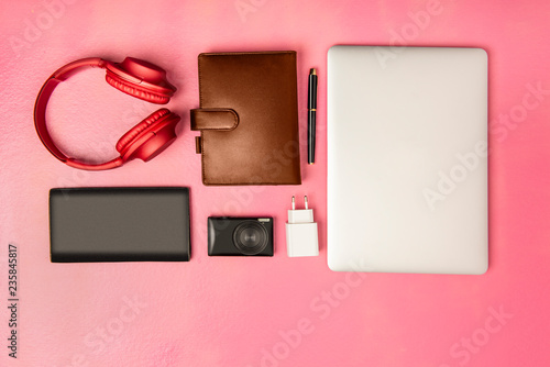 Businessman equipment like laptop, pen, notebook, camera, wallet and headphones for work