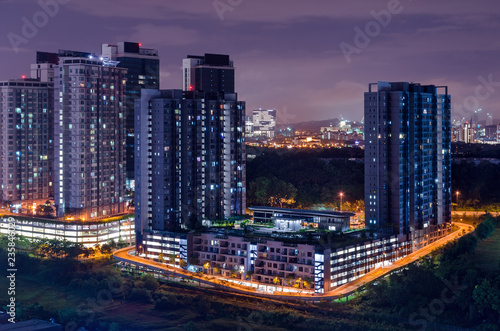 Dark city scene, night hours, light is on in the houses, the end of the day. Skyline Cyberjaya, Malaysia.
