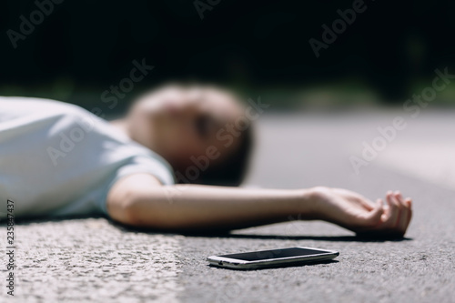 Tableau sur toile Close-up on a smartphone and careless victim of a traffic accident on a crosswal