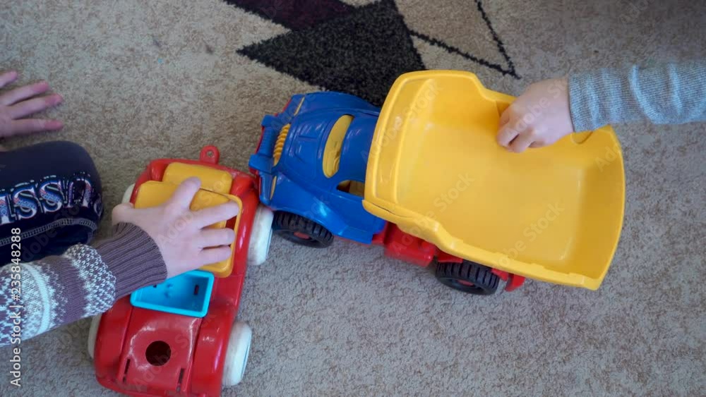 children play with cars on the carpet children play with cars on the carpet