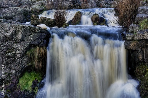 Fototapeta Naklejka Na Ścianę i Meble -  Water flowing and dropping in small waterfall