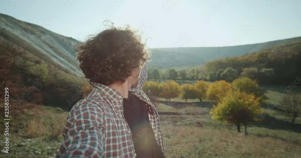 A very charismatic guy have a trip in the middle of nature , he taking selfie video of himself smiling and showing the beautiful landscape of nature. A very charismatic guy have a trip in the middle of nature , he taking selfie video of himself smiling and showing the beautiful landscape of nature.