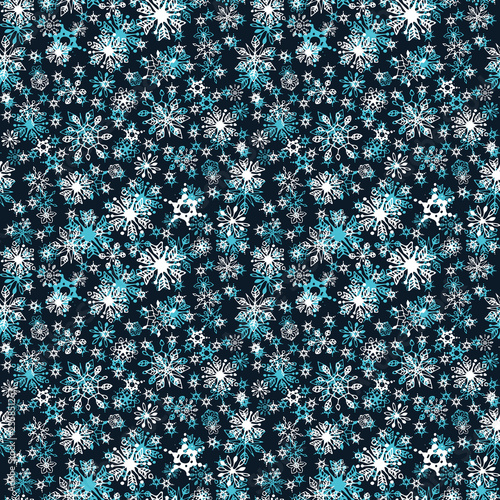 Snowfall. A lot of bright snowflakes on the dark. Seamless pattern.