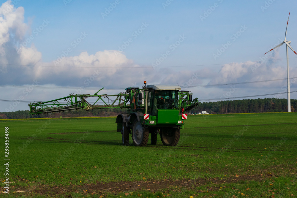 Fototapeta premium ein Düngetraktor klappt seine Sprüharme ein