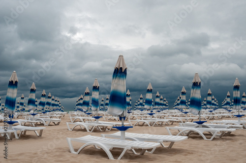 Closed beach sunshades on the seaside © ggaallaa