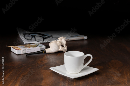 Kaffeetasse mit Tabakpfeife und Zeitung
