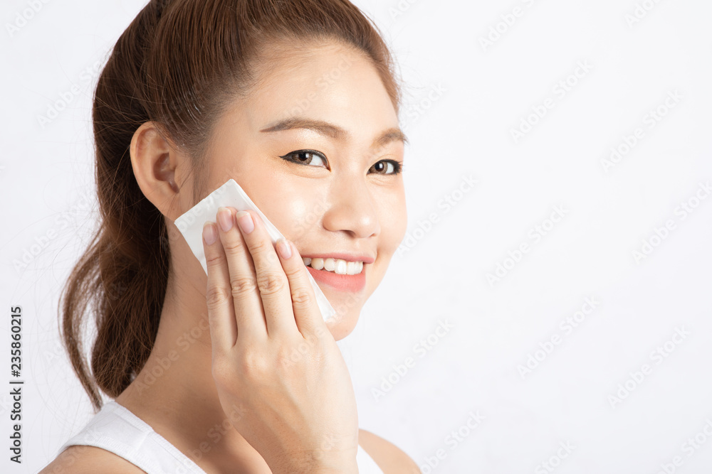 Attractive Charming Asian young woman smile and using tissue with toner for cleaning make up feeling so fresh and clean with healthy skin,isolated on white background,Beauty Cosmetics Concept Attractive Charming Asian young woman smile and using tissue with toner for cleaning make up feeling so fresh and clean with healthy skin,isolated on white background,Beauty Cosmetics Concept