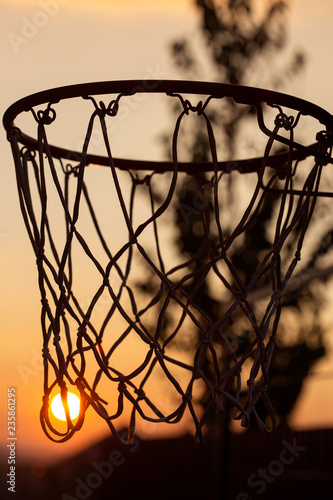 Silhouette of a basketball hoop  under the sunset