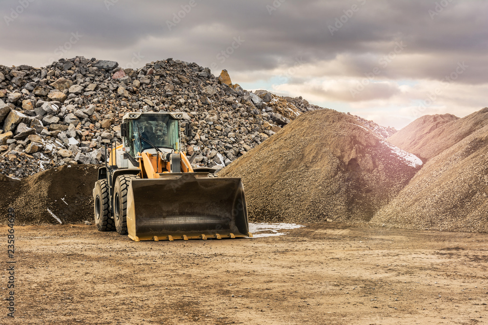 Quarry aggregate with heavy duty machinery. Construction industry. - obrazy, fototapety, plakaty 
