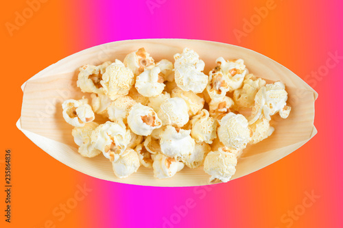 Top view  popcorn ,snack in bamboo nature bowl in boat shape, mixcolor background and clipping path, concept snack for party in christmas holiday with family. photo