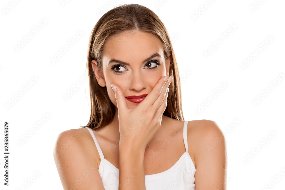 Portrait of young beautiful ashamed and smiling girl on white backgeound Portrait of young beautiful ashamed and smiling girl on white backgeound