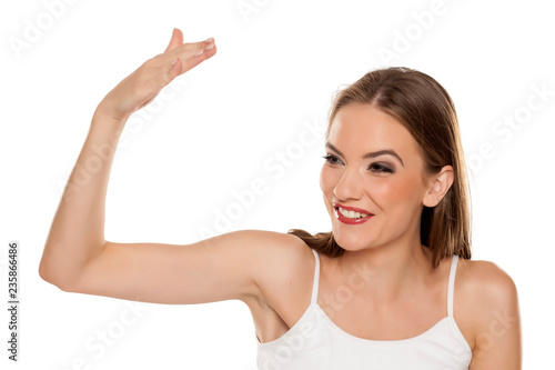 young beautiful woman calls someone with a hand gesture