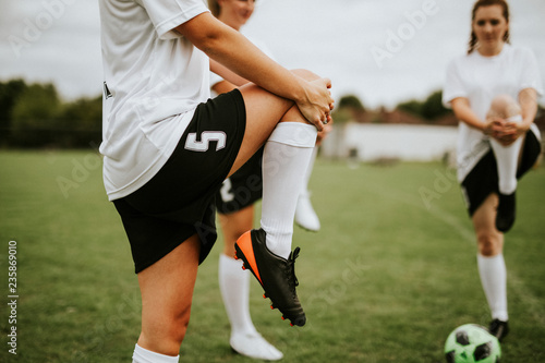 Fototapeta Naklejka Na Ścianę i Meble -  Female soccer team players stretching pre game