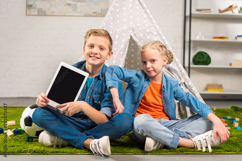 happy little kids showing digital tablet with blank screen near tent at home happy little kids showing digital tablet with blank screen near tent at home