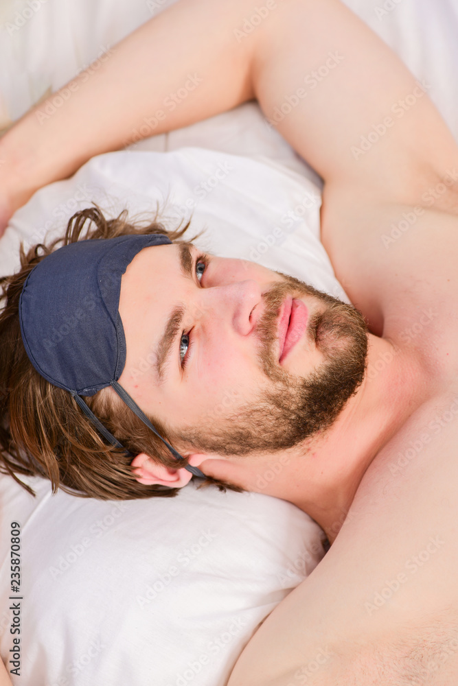 Lazy man happy waking up in the bed rising hands in the morning with fresh feeling relaxed. Man stretching in bed. Morning of a new day, alarm clock waking up man stretch the muscles, health concept. Lazy man happy waking up in the bed rising hands in the morning with fresh feeling relaxed. Man stretching in bed. Morning of a new day, alarm clock waking up man stretch the muscles, health concept.