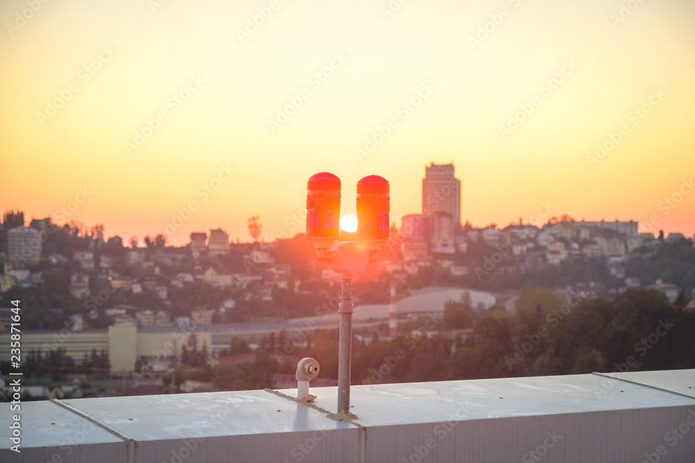 red lights on the roof of a high-rise building for the safety of buildings and air transport red lights on the roof of a high-rise building for the safety of buildings and air transport