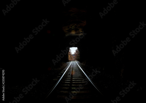 Railroad Tunnel into daylight long distance copy space light at end of tunnel