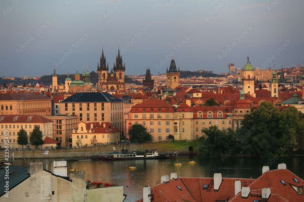 Prague, Czech Republic, September 19, 2018. Beautiful view from above on the city, red roofs of houses, the Vltava River and the Temple in the evening light